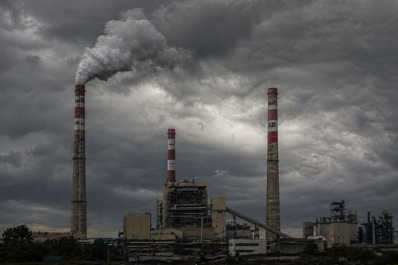 Industriekamine gegen dunklen Gewitterhimmel — Umweltstrafrecht und Compliance-Pflichten
